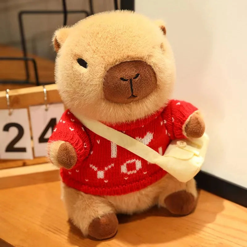 Kawaii teddy bear wearing a red sweater with white text on a wooden surface.