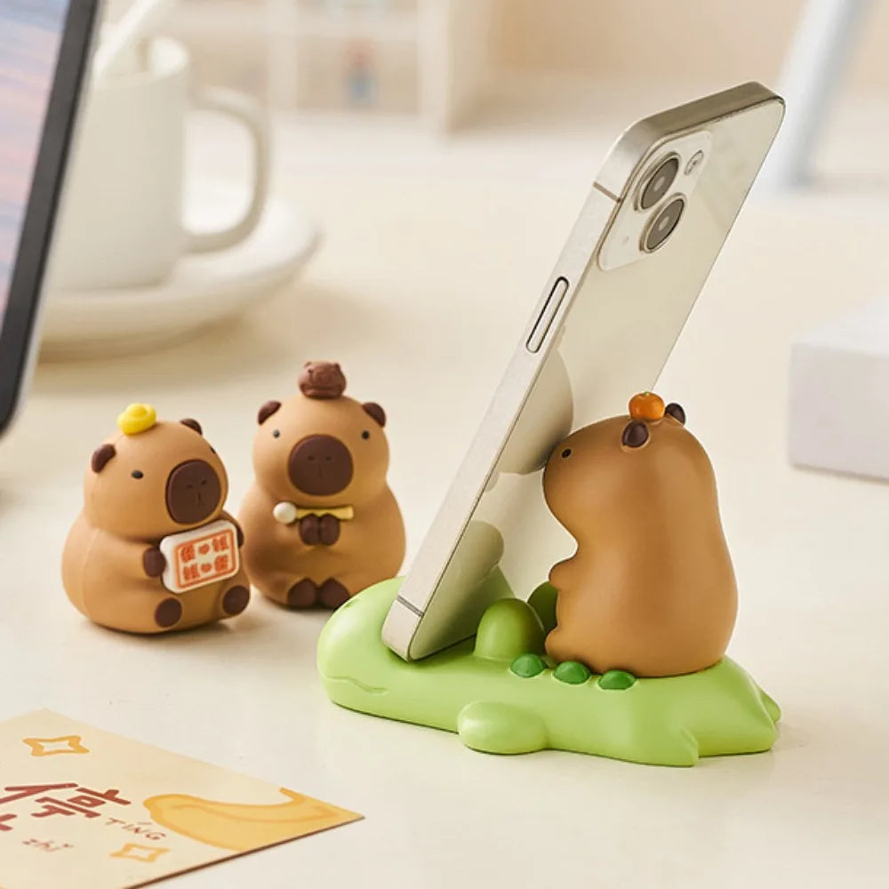 Kawaii phone holder with cartoon animal design on a desk