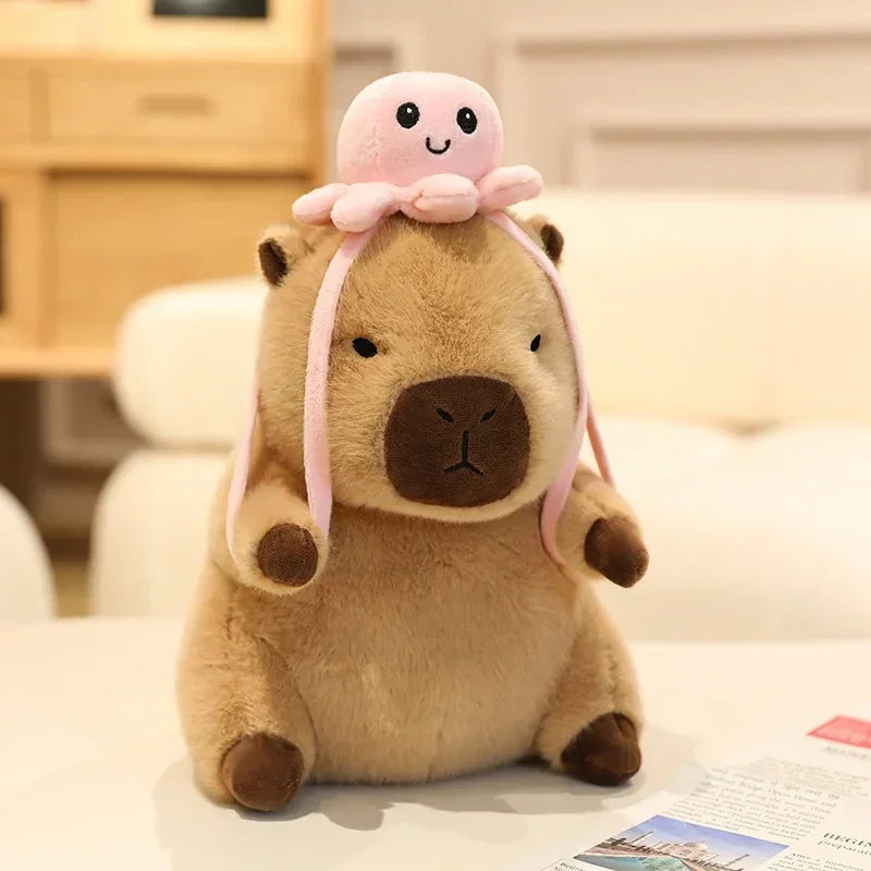 Kawaii plush toy with a pink octopus on its head sitting on a surface.