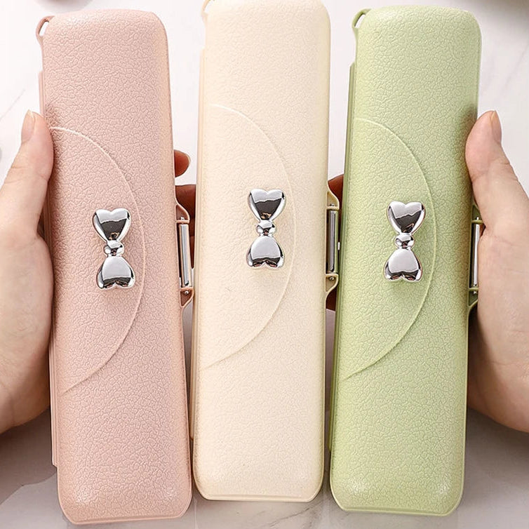 Three small kawaii utensils in pink, beige, and green held by hands on a light background.