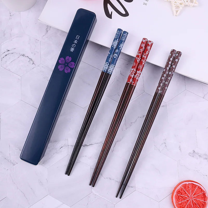 Set of decorative kawaii chopsticks with a black case on a marble surface