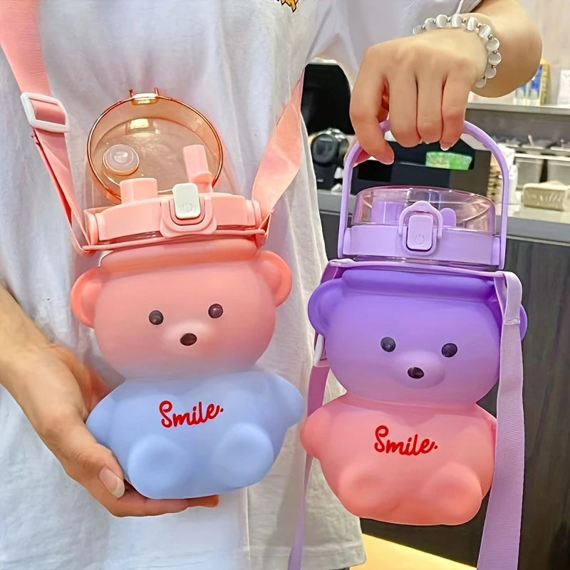 Two bear-shaped kawaii water bottles, one pink and one purple, held by a person.
