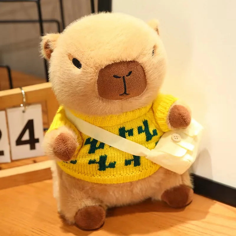 Kawaii plush bear toy wearing a yellow sweater with green text on a wooden surface.