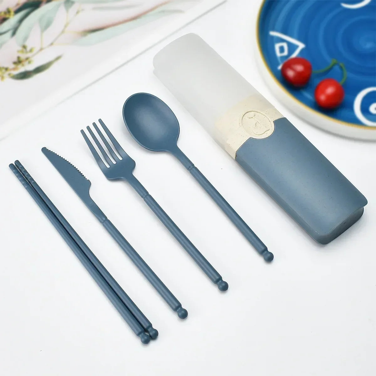 Blue kawaii utensils set with a case on a white surface