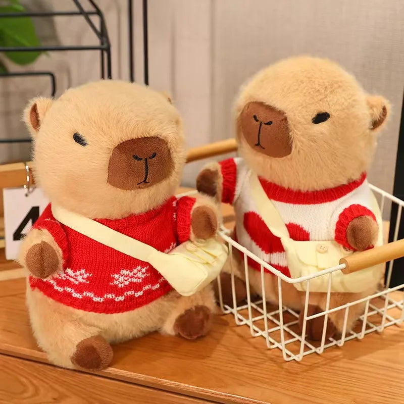 Two kawaii teddy bears wearing red sweaters with white patterns on a wooden surface.