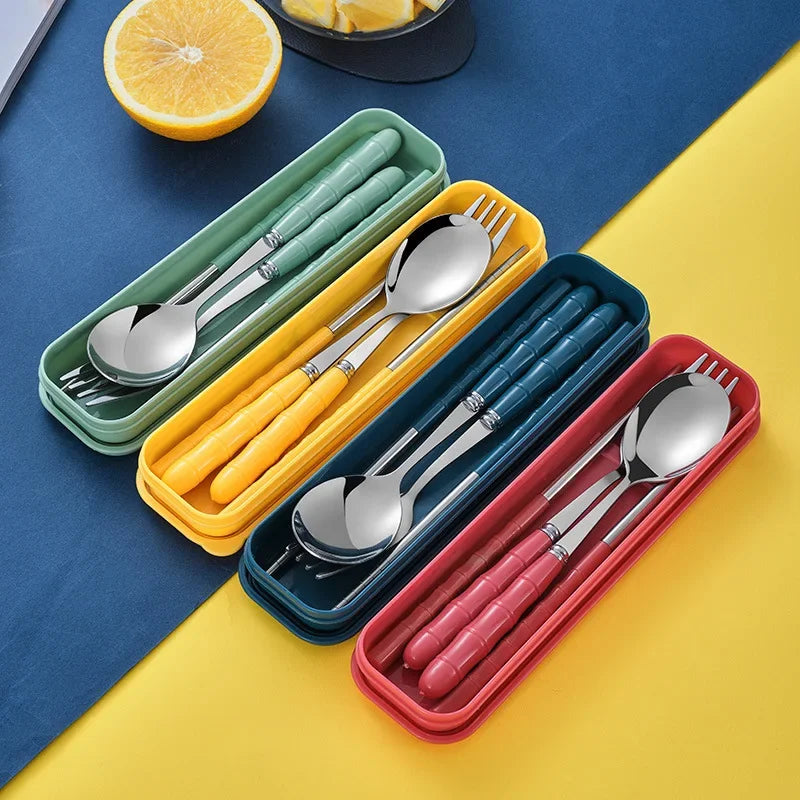 Set of silver kawaii utensils in colorful cases on a blue and yellow background
