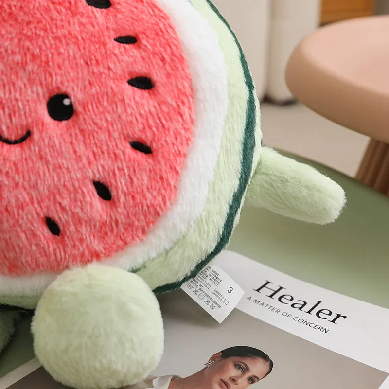 Kawaii plush watermelon toy on a magazine with 'Healer' visible