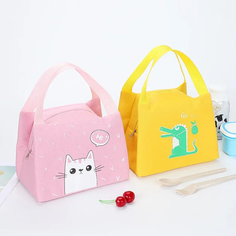 Pink and yellow kawaii lunch bags with cartoon designs on a white background