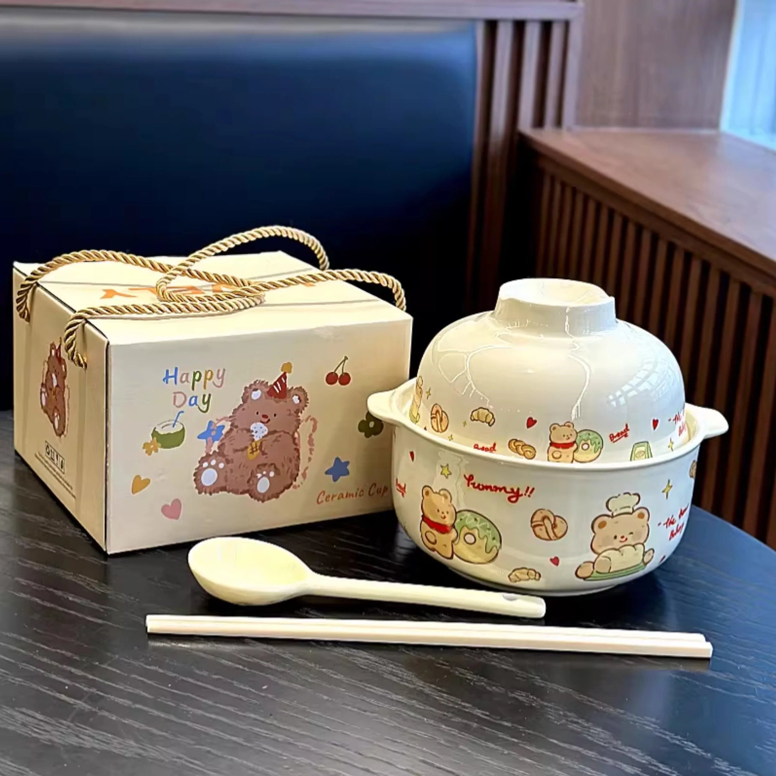 A cartoon themed kawaii ramen bowl with spoon sitting on a table
