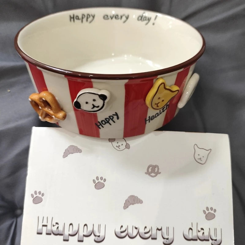 A small red and white striped kawaii ramen bowl with decorative designs on it