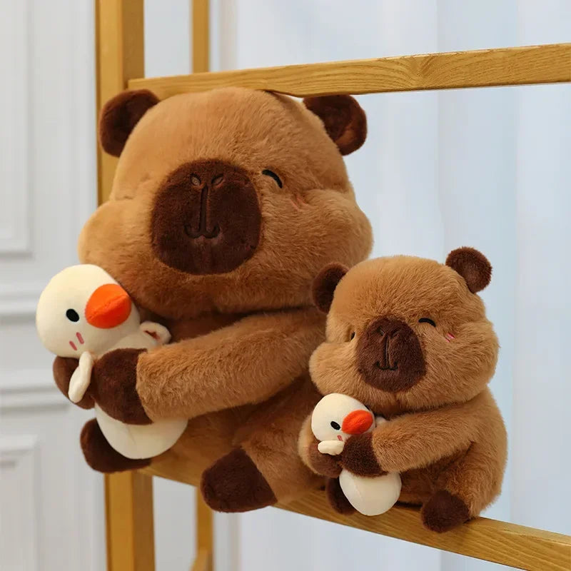 Two brown kawaii plush toys holding small white birds on a wooden surface.
