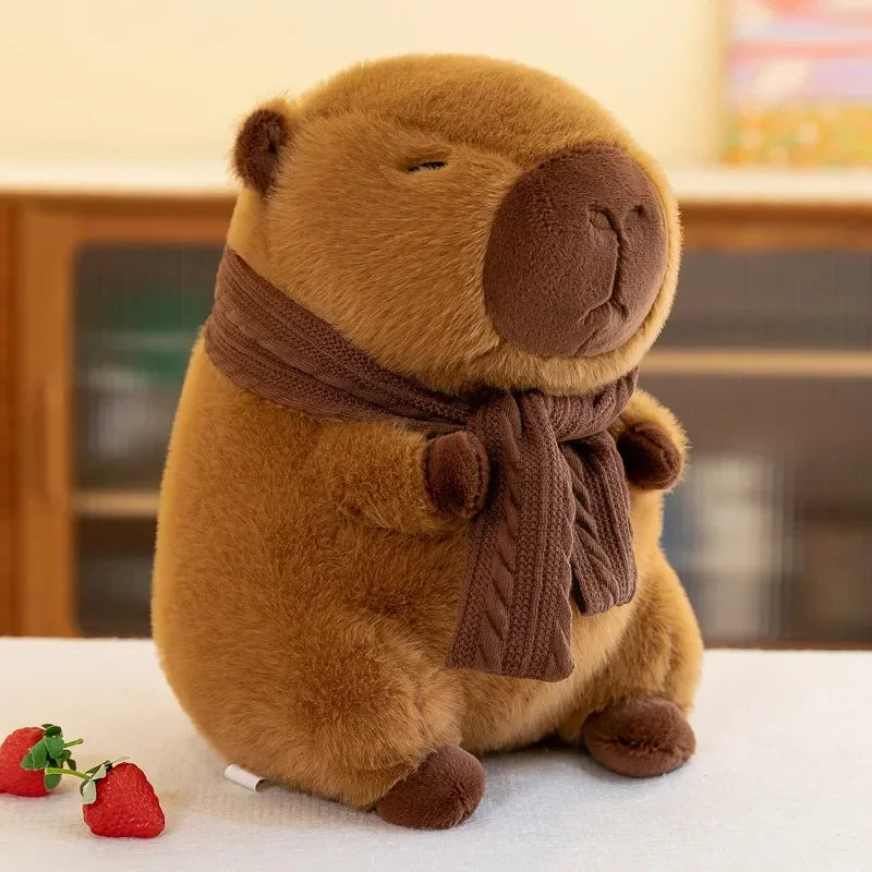 Kawaii plush groundhog toy with a brown scarf on a white surface