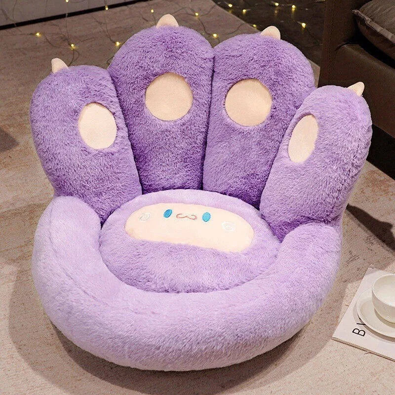 Purple paw-shaped kawaii cushion on a floor with a blurred background