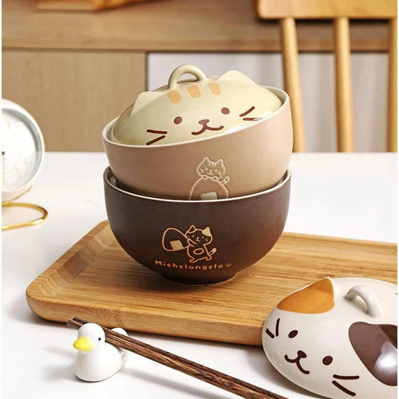Set of cat-themed ceramic kawaii ramen bowls on a wooden tray with a white background