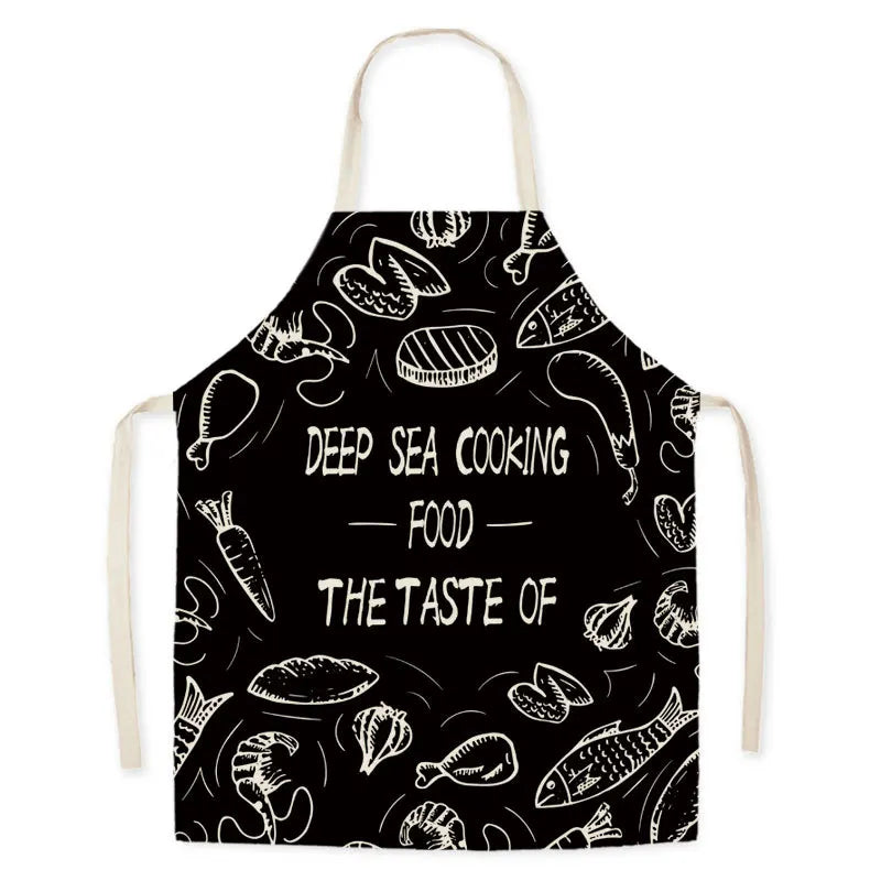 Black kawaii apron with white fish illustrations and text on a white background