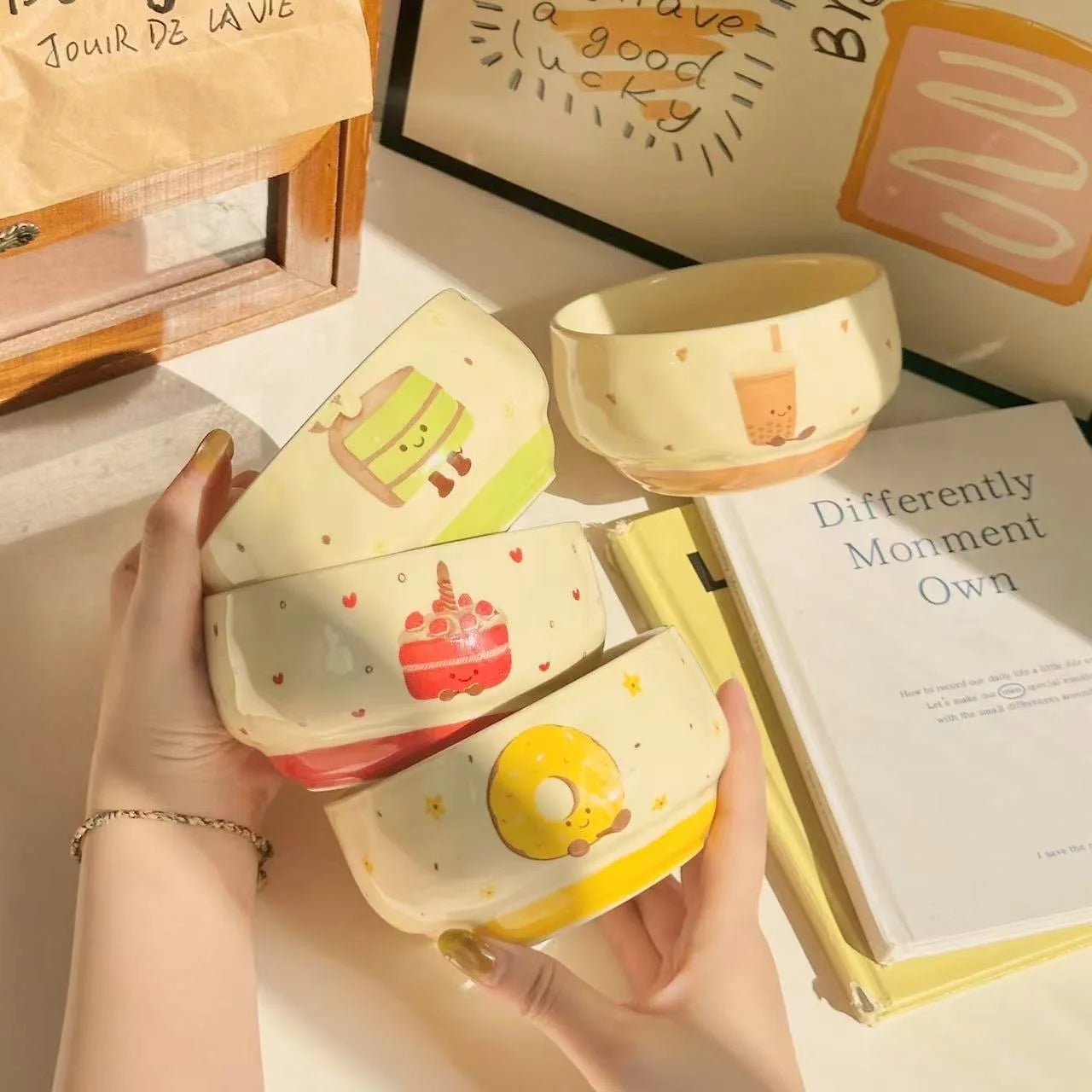 A group of four kawaii bowls being held by someone