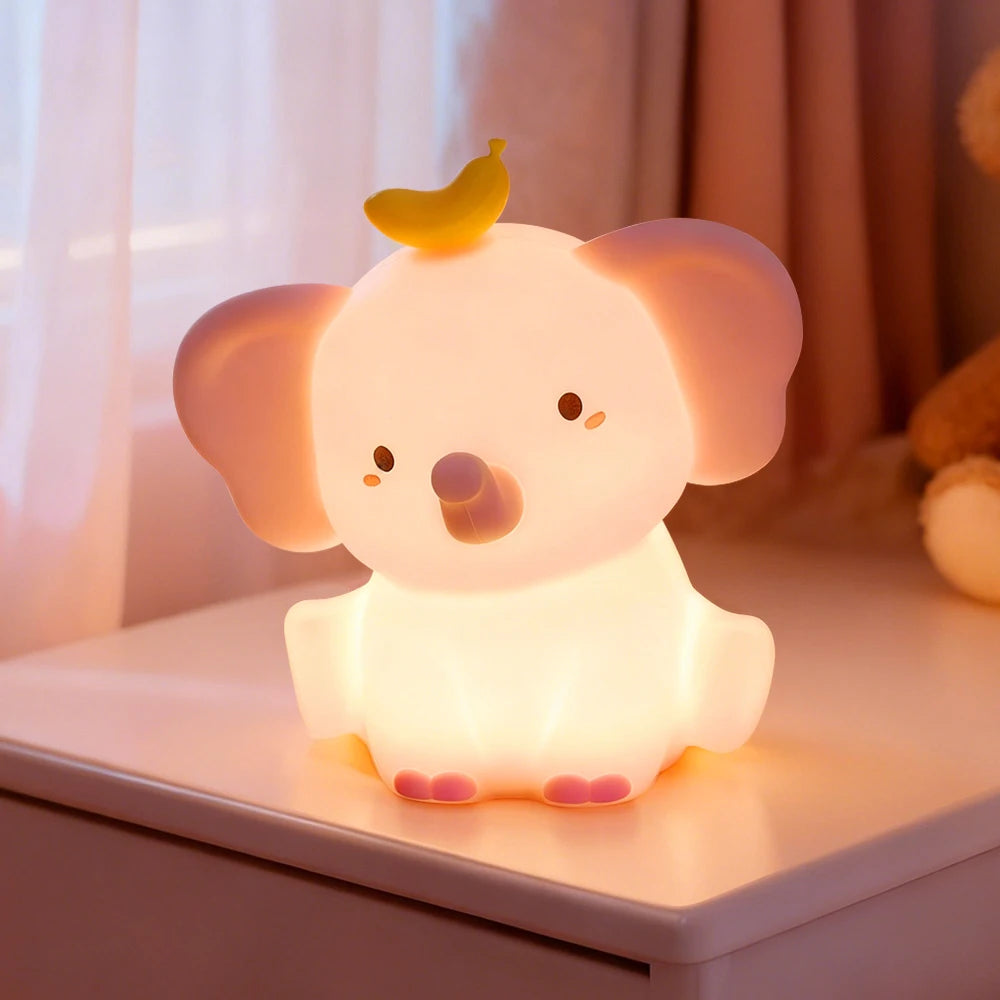 Cute elephant-shaped kawaii night light on a surface with a soft, warm glow.