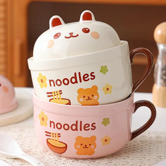 Set of two cute ceramic kawaii ramen bowls with animal faces on a table.