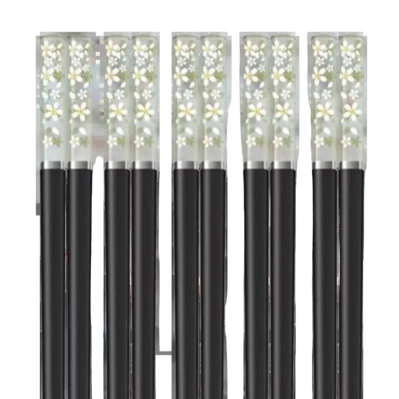 Set of kawaii chopsticks with floral designs on a white background