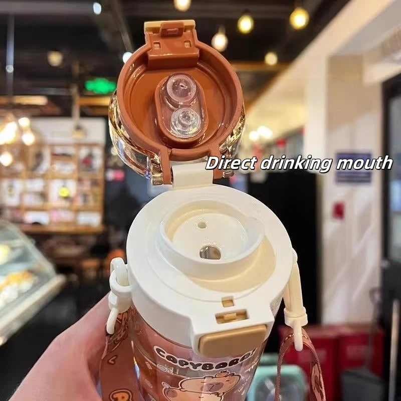 Close-up of a kawaii coffee cup with a lid open, showing the 'Direct drinking mouth' feature, in an indoor setting.
