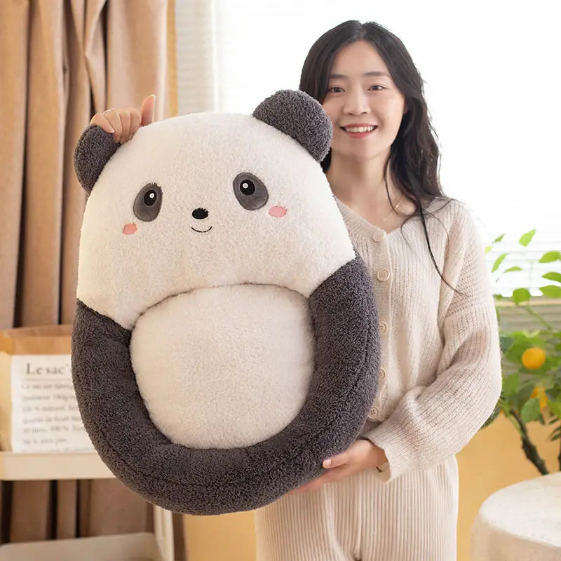 Person holding a large, kawaii plush panda toy in a home setting