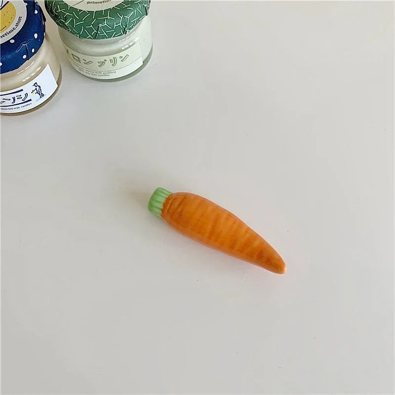 Carrot-shaped kawaii chopstick holder on a light gray surface with jars in the background