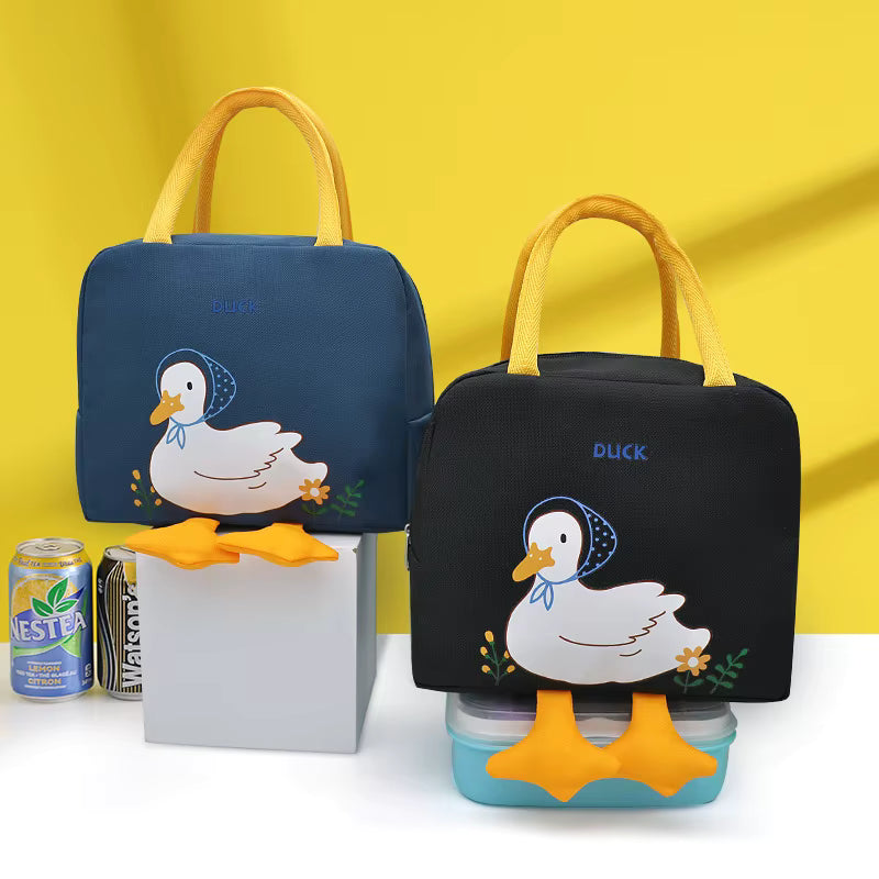 Two duck-themed lunch bags shown on a white surface against a bright yellow background. One bag is dark blue and the other is black, both with yellow handles and a white duck illustration with orange beaks and feet.