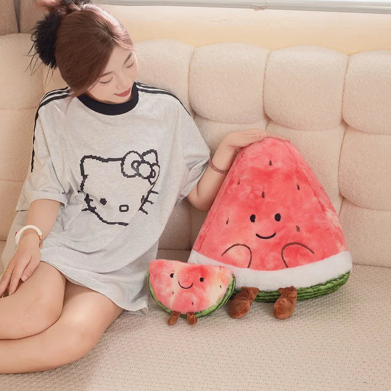 Person sitting on a couch holding a kawaii plush watermelon toy