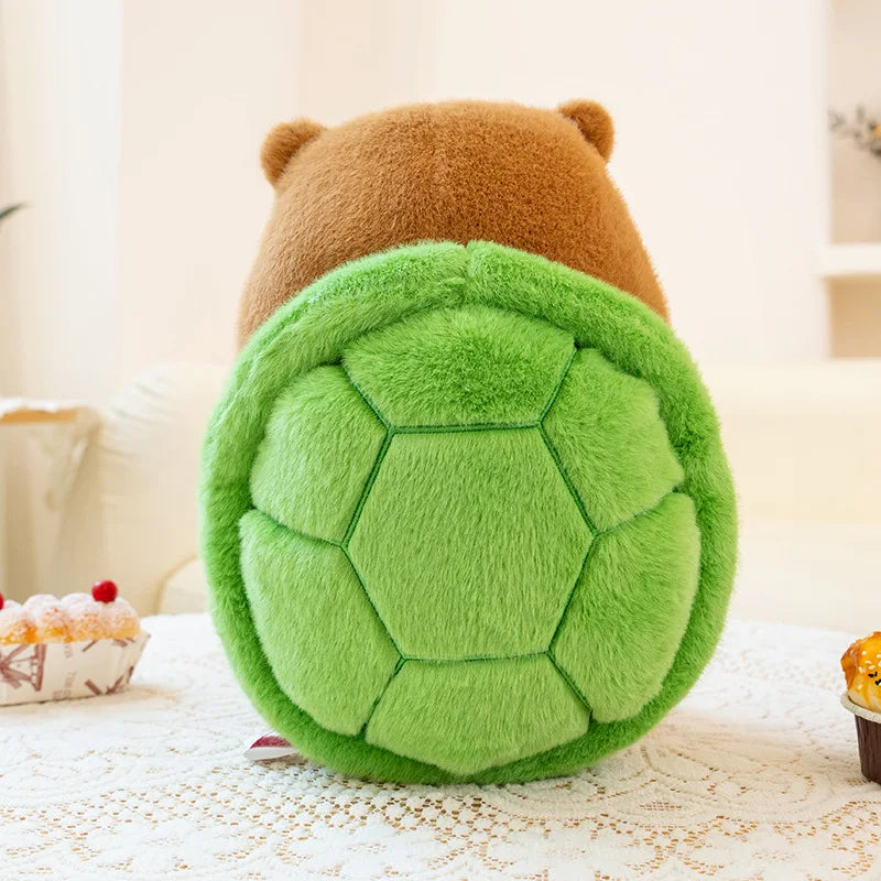 Kawaii plush toy with a brown bear head and green turtle shell on a light surface.