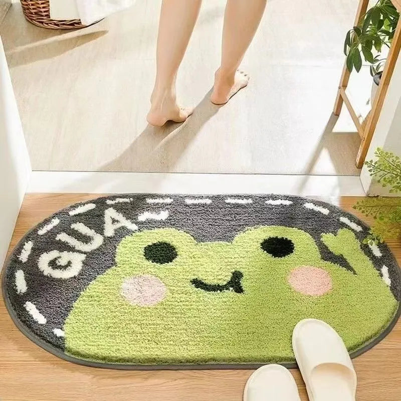 Round green Kawaii frog rug with 'GUA' text on a wooden floor.
