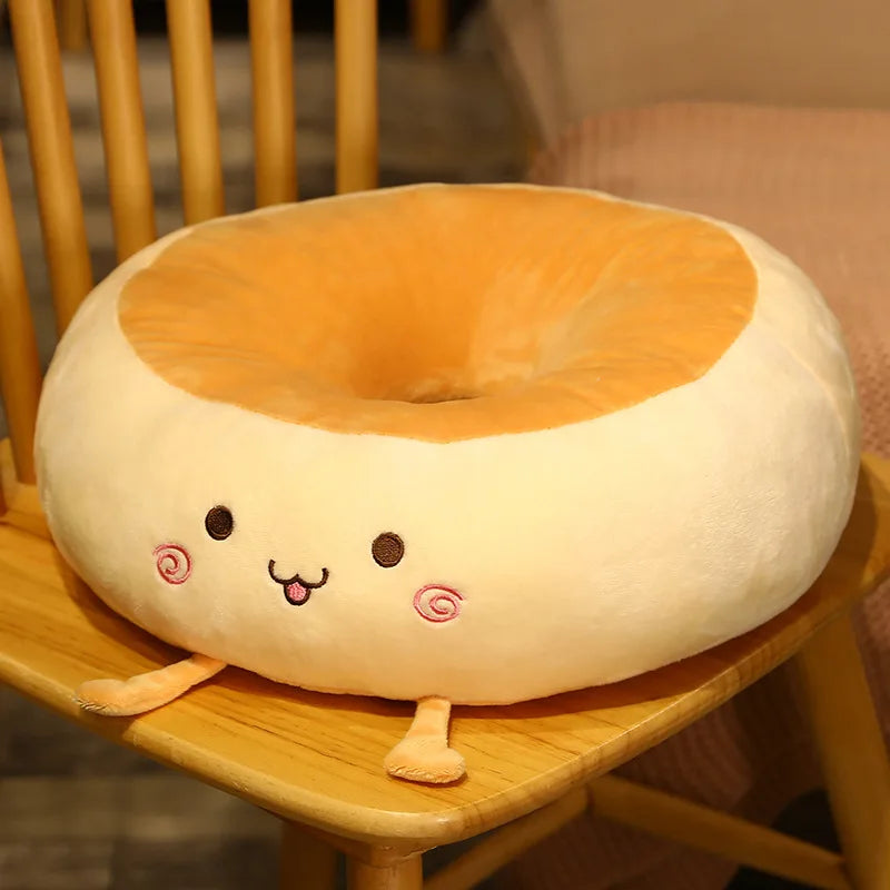 Plush donut-shaped kawaii pillow with a face on a wooden chair