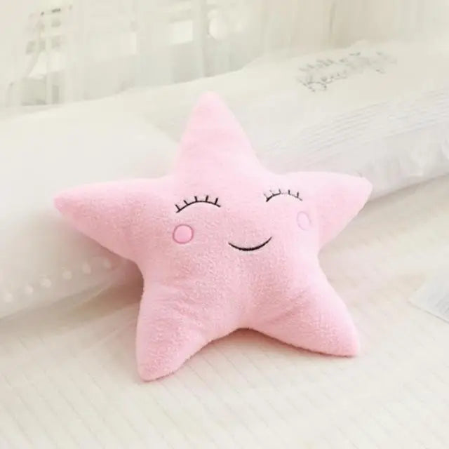 Pink star-shaped kawaii plush toy with a smiling face on a soft white background