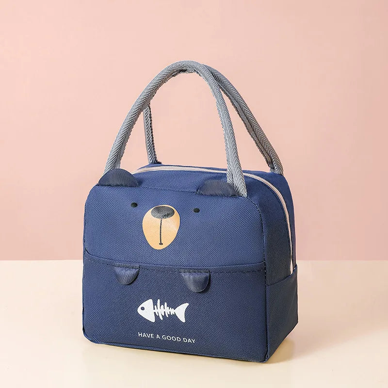 Blue bear-shaped kawaii lunch bag with a fish design and text on a pink background