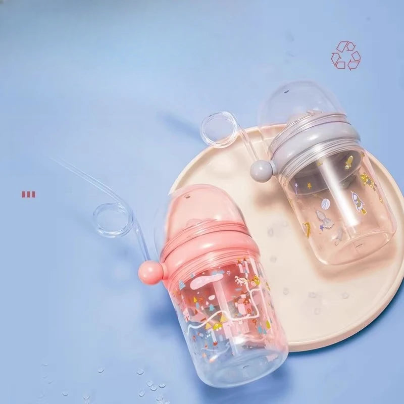 Two kawaii water bottles with pink and clear designs on a light blue background