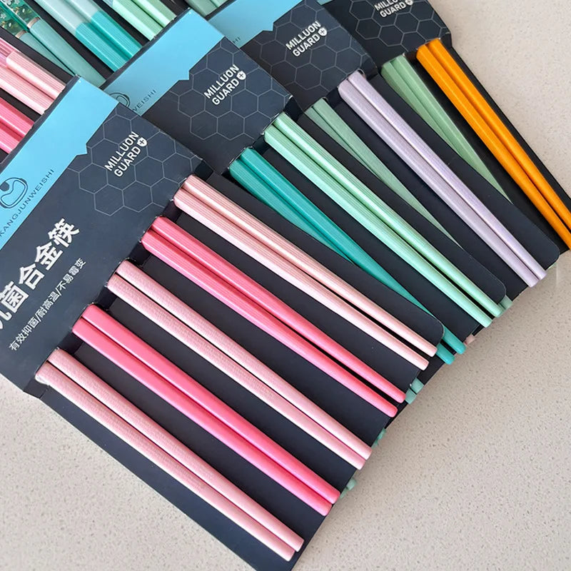 Set of colorful kawaii chopsticks in packaging on a light background