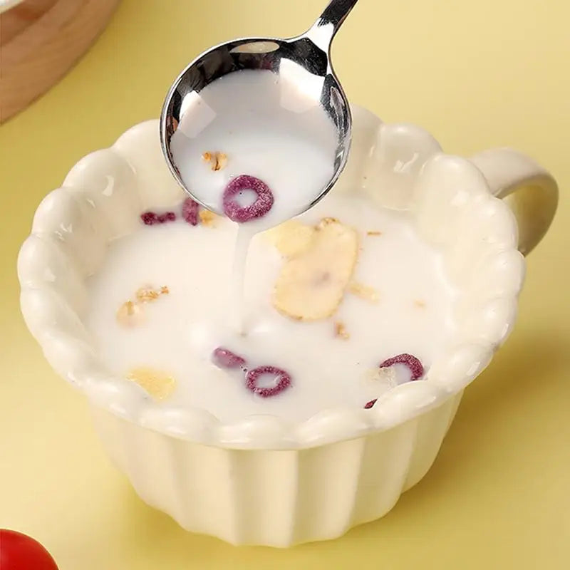 A close up of a steel kawaii utensils inside a mug