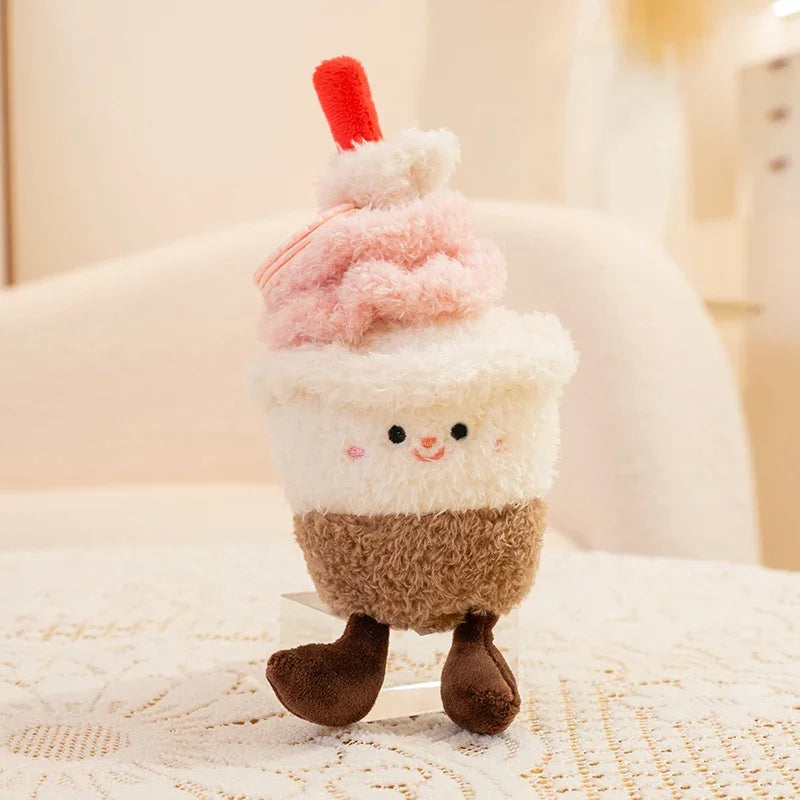 Kawaii plush toy resembling a cupcake with a cherry on top on a textured surface.