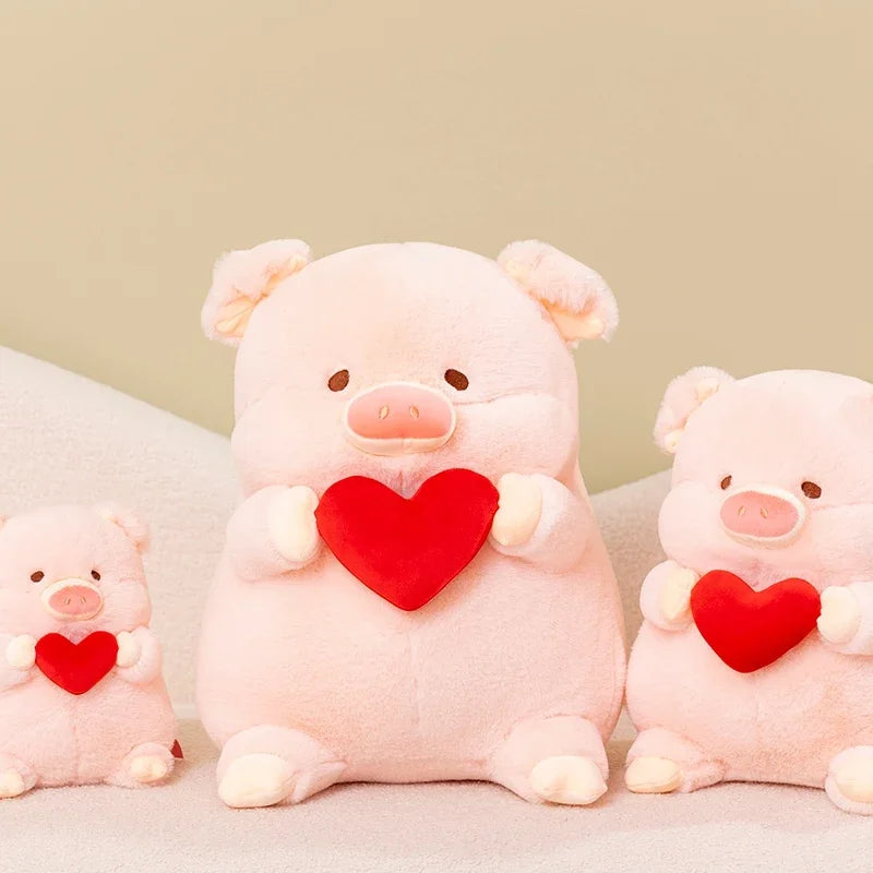 Three pink kawaii plush pigs holding red hearts on a light background