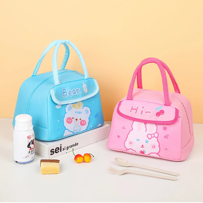 Two cartoon-themed kawaii lunch bags, one blue and one pink, on a white surface with a yellow background.