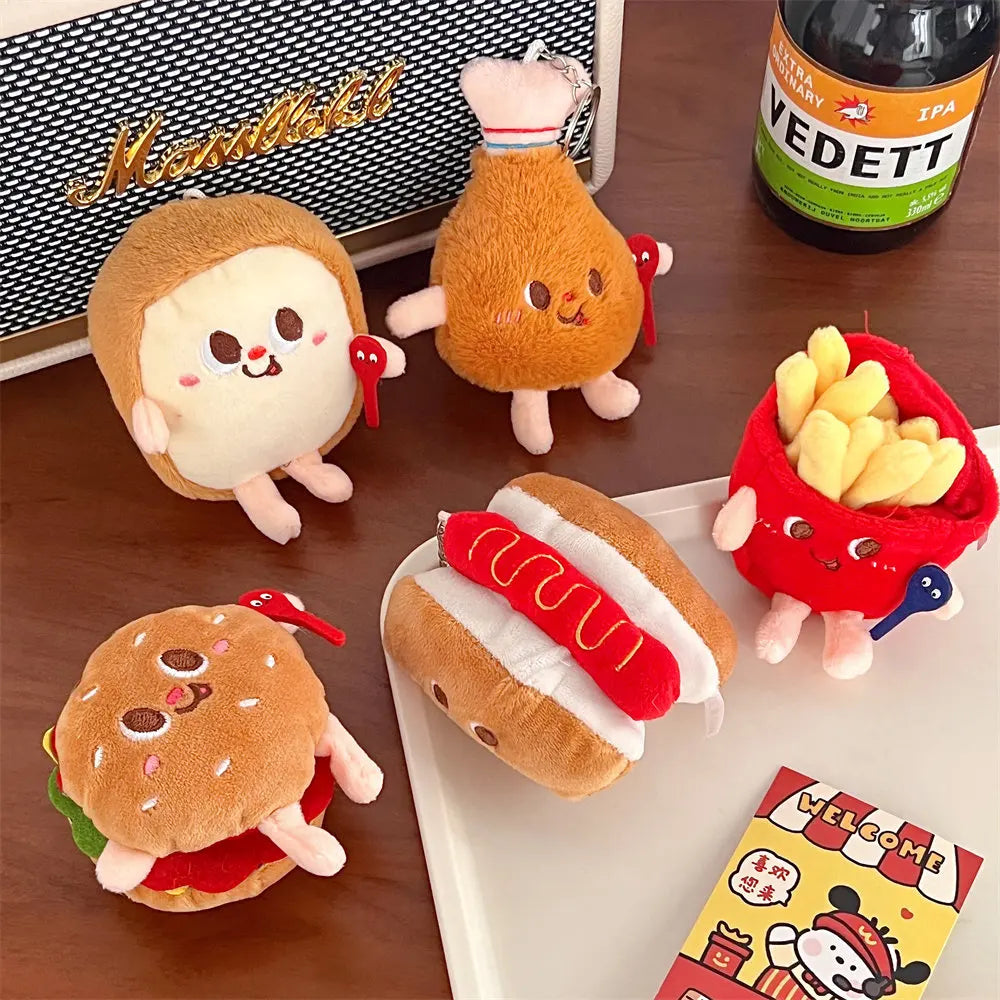 Plush kawaii toys resembling food items on a table with a bottle of Vedett beer in the background.