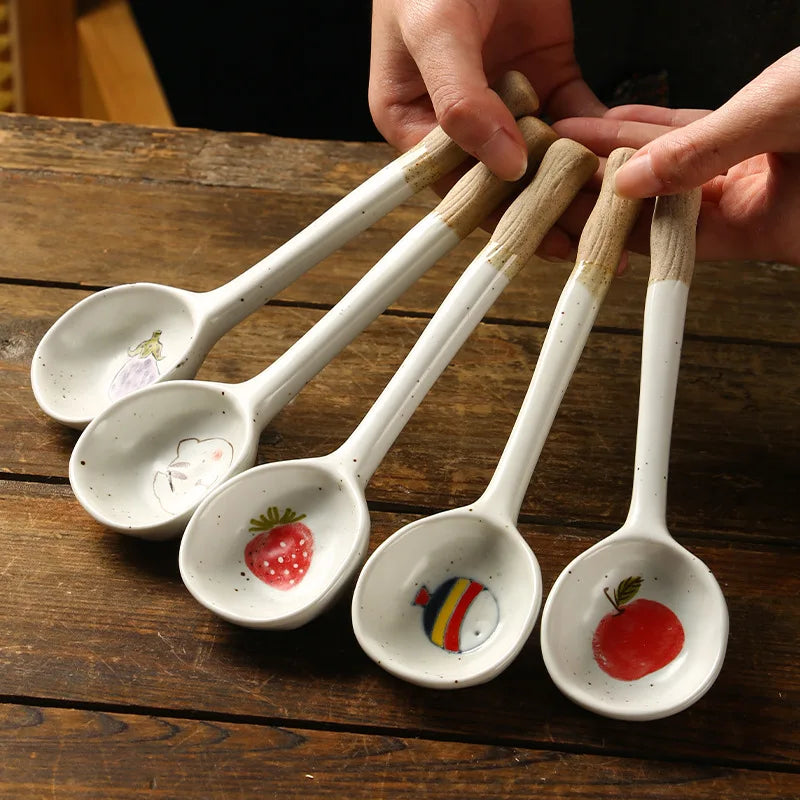 Someone holding a set of five kawaii spoons