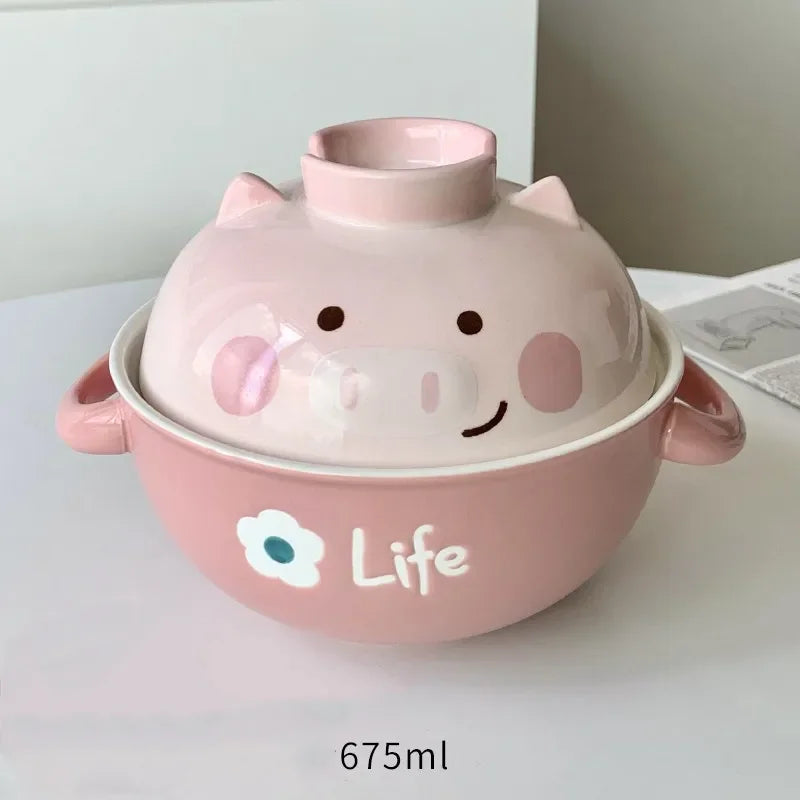 Pink pig-shaped kawaii ramen bowl with a lid on a white surface