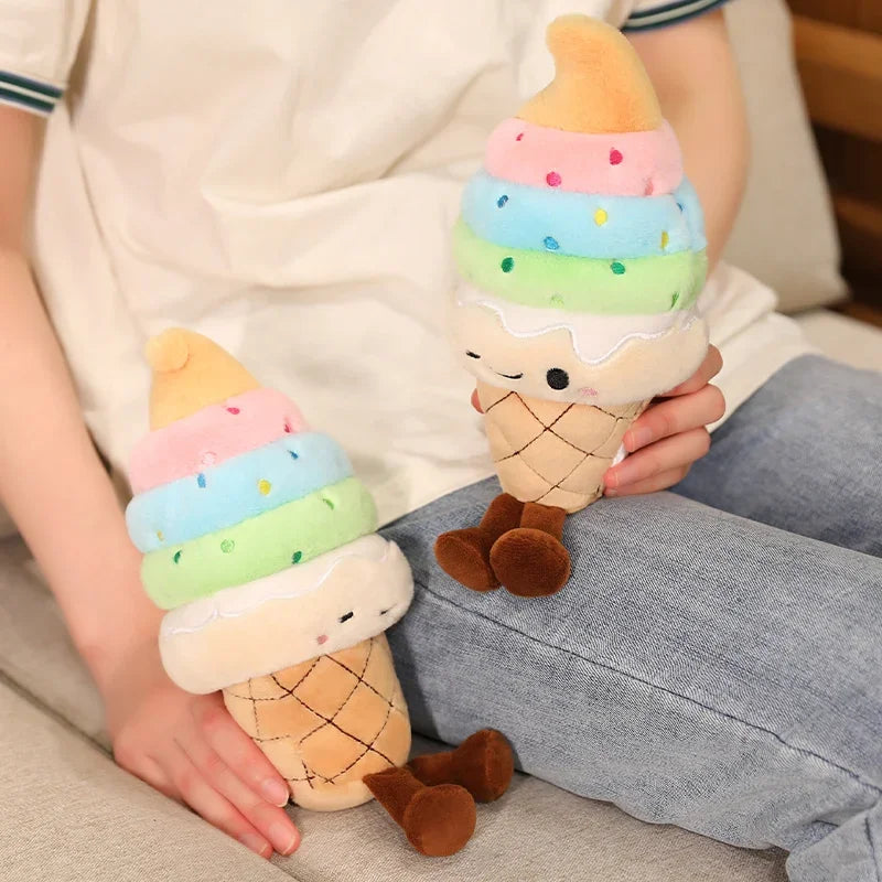 Two kawaii plush ice cream cone toys held by a person on a couch.
