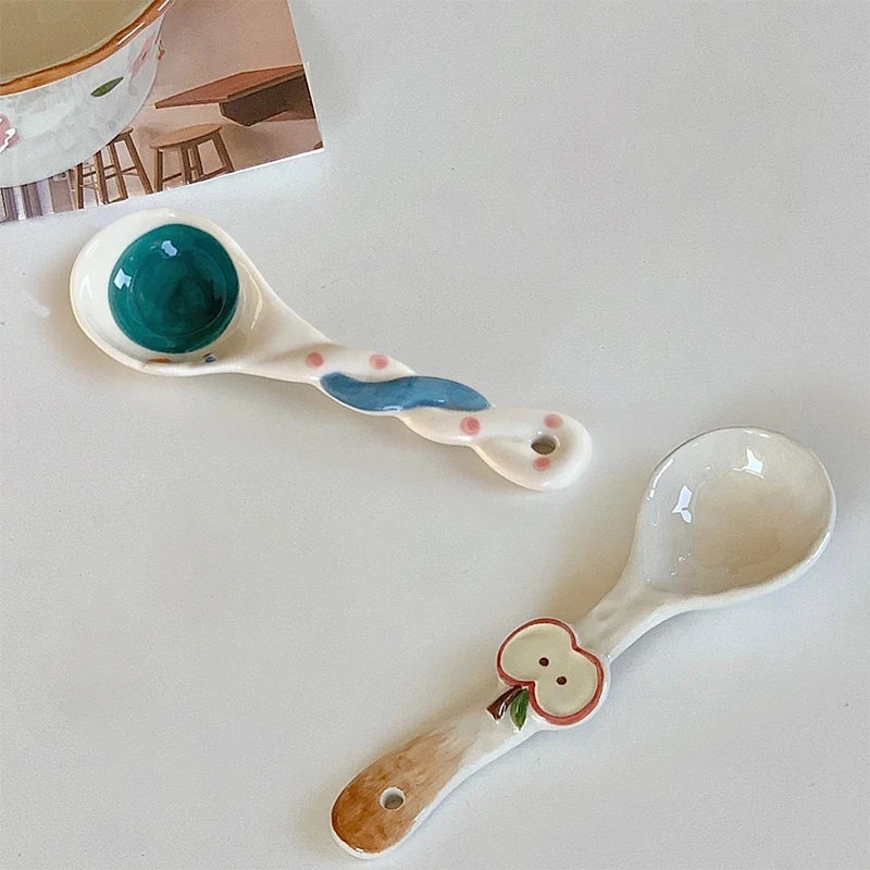 Two white ceramic kawaii spoons on a table