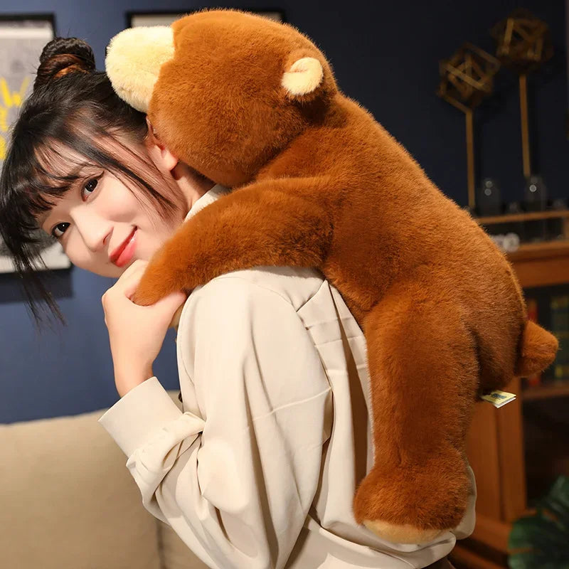Person holding a large brown kawaii teddy bear in an indoor setting
