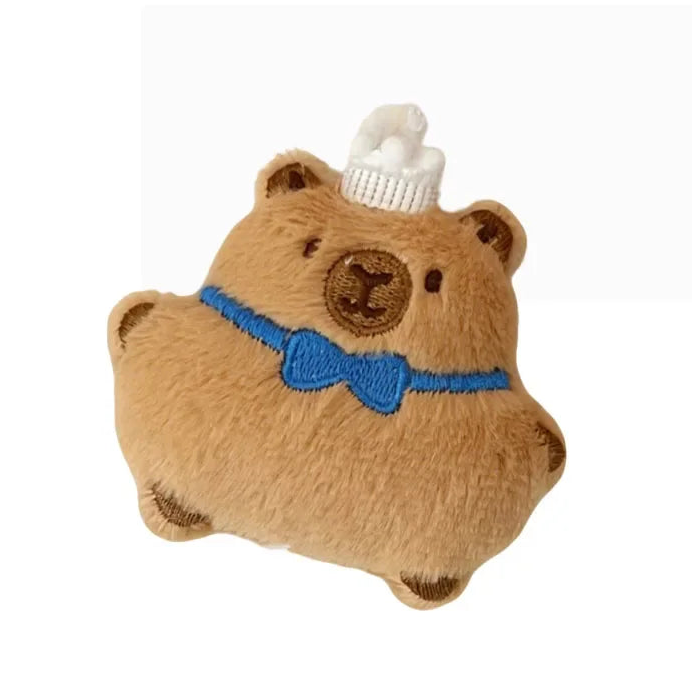 Plush kawaii toy bear with a white hat and blue bow tie on a white background