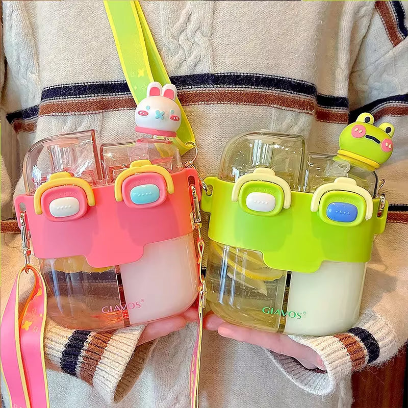 Two colorful kawaii water bottles with cartoon character holders held by a person wearing a patterned sweater.