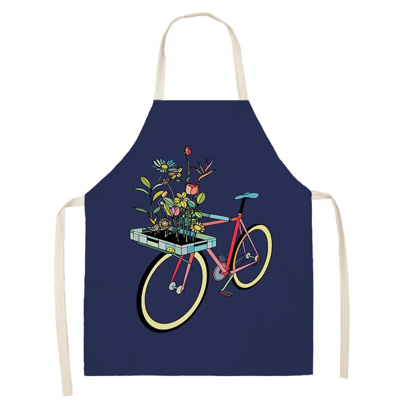 Navy blue kawaii apron with a bicycle and flower basket design on a white background