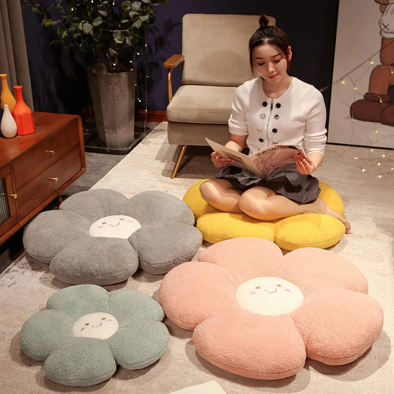 Woman reading a book on a yellow flower-shaped kawaii cushion in a room with decorative pillows.
