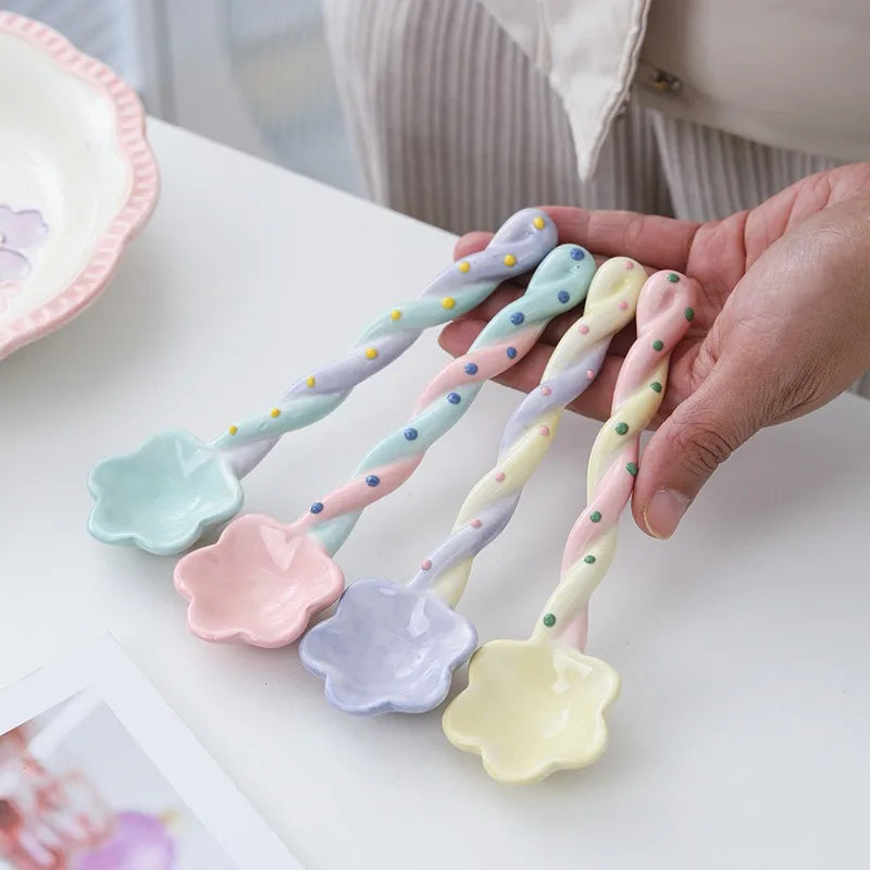 A person holding a set of four kawaii spoons
